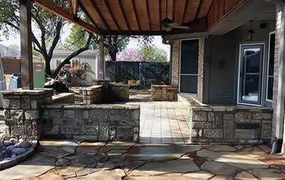 Outdoor living area with patio and stone work by Martinez Brothers Concrete and Landscaping