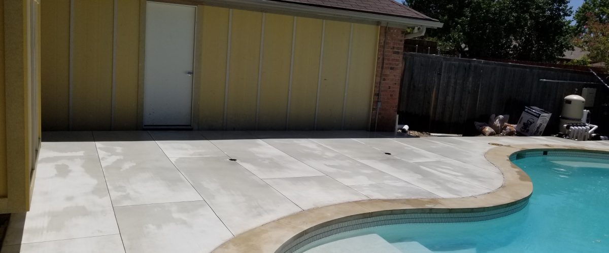 Concrete patio around a pool
